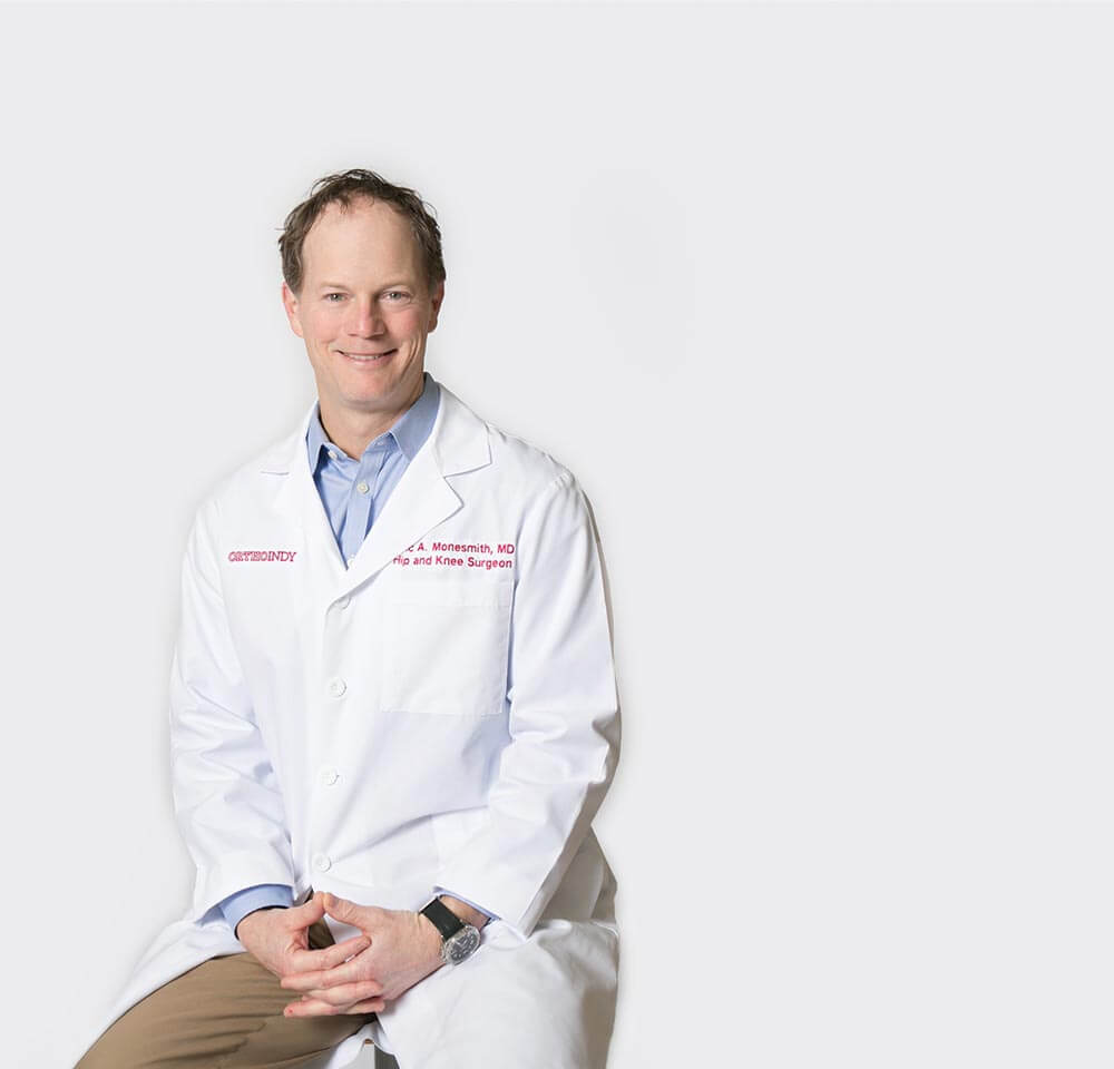 M.D. Eric Monesmith portrait in front of a plain white background