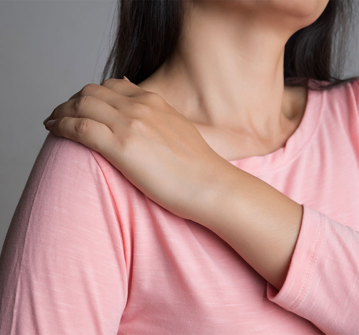 woman holding neck in pain